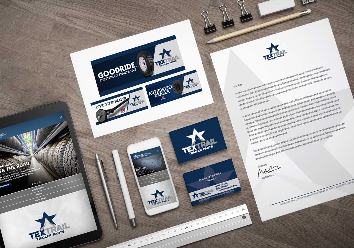 Table covered in TexTrail brand assets like advertisements, letterheads, and business cards