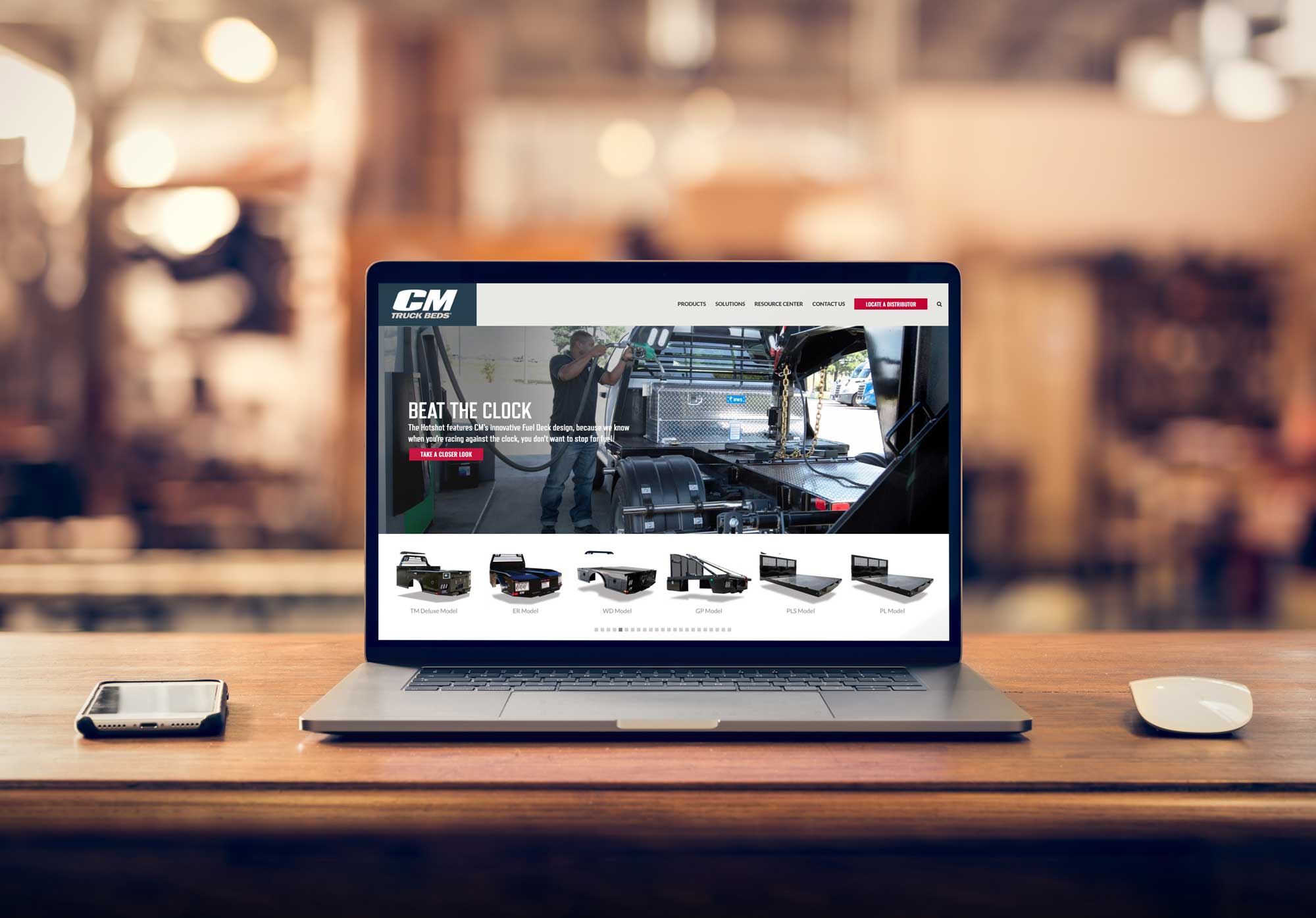 CM Truck Beds website displayed on a laptop screen