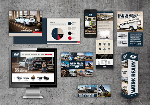 Collection of CM Truck Beds ads, magazines, and webpages on a concrete background